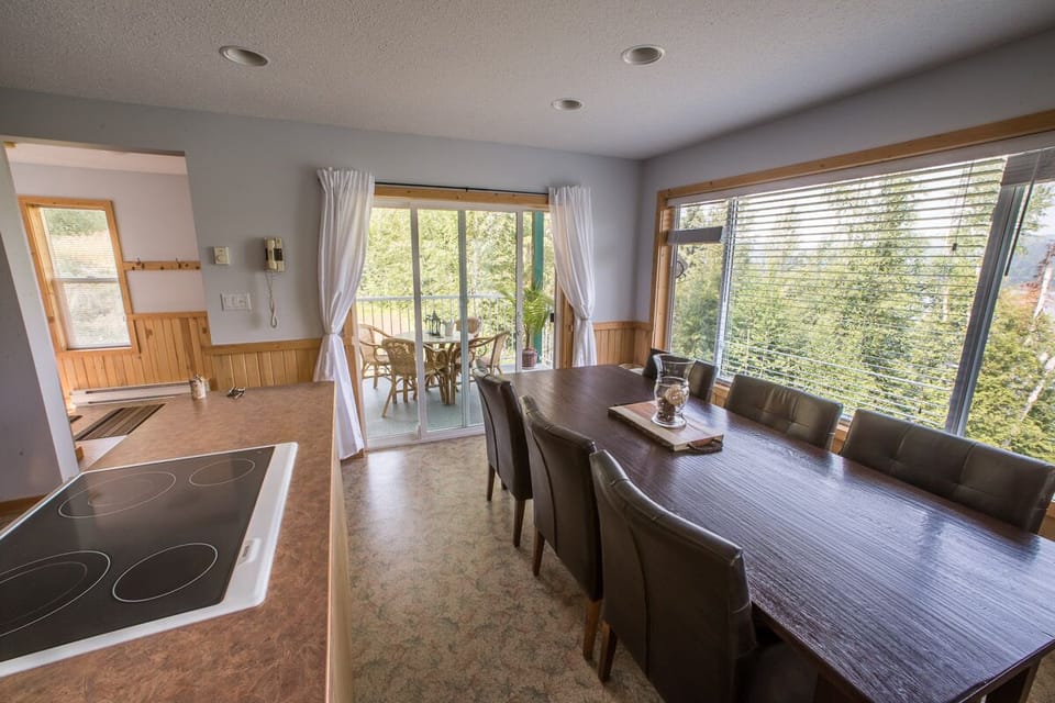 Eight foot dining table and outdoor breakfast nook with gorgeous lake views