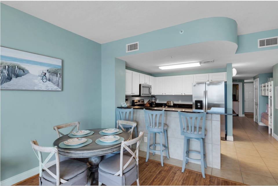 Gather around your spacious kitchen island or cozy dining table in this bright, beach-inspired space with modern appliances and coastal charm.
