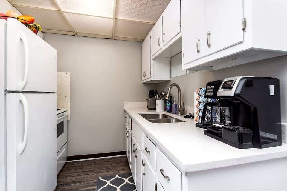 Kitchen setup with all option coffee maker, microwave, toaster,stove and fridge. It comes with everything you'll need to cook for a stay of any length. 