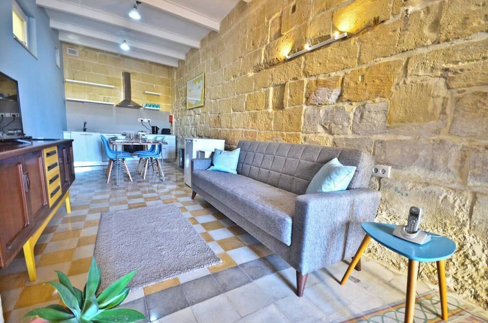 Living area equipped with a sofa bed and a flat-screen Cable TV for entertainment.
