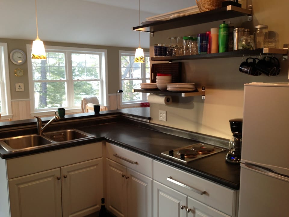 Kitchen: double basin sink, two-burner stove, coffee maker, refrigerator/freezer