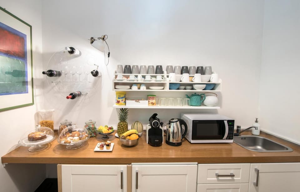 Full-size fridge, microwave, coffee/tea maker, cookware/dishes/utensils