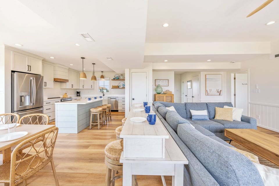 The expansive second floor encompasses the great room, kitchen, dining area, oceanfront deck, and sound-facing balcony.