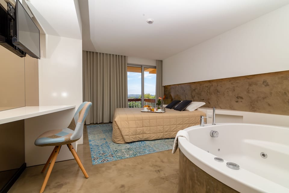 Deluxe Double Room, Jetted Tub, River View | Pillowtop beds, in-room safe, desk, iron/ironing board