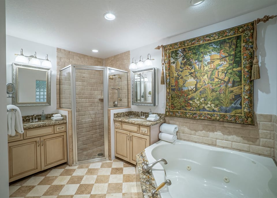 The luxury master bathroom has all necessary amenities plus plush white towels.