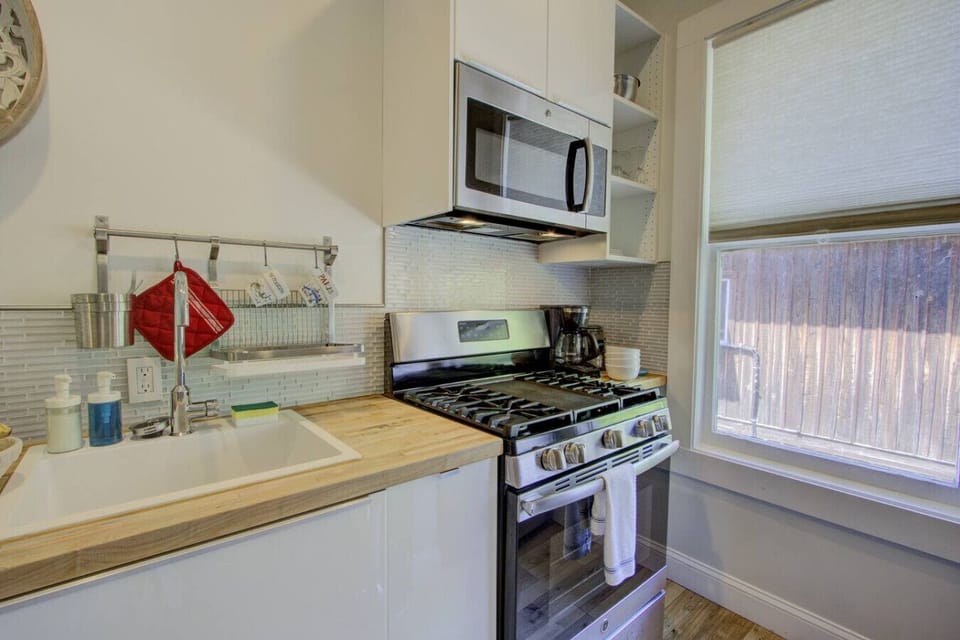 Cozy kitchen equipped with a full stove, microwave, and coffee maker—perfect for cooking at home or enjoying your morning brew.