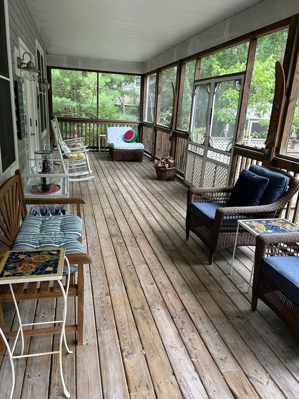 Screened porch has doors opening to 3 sides of house.