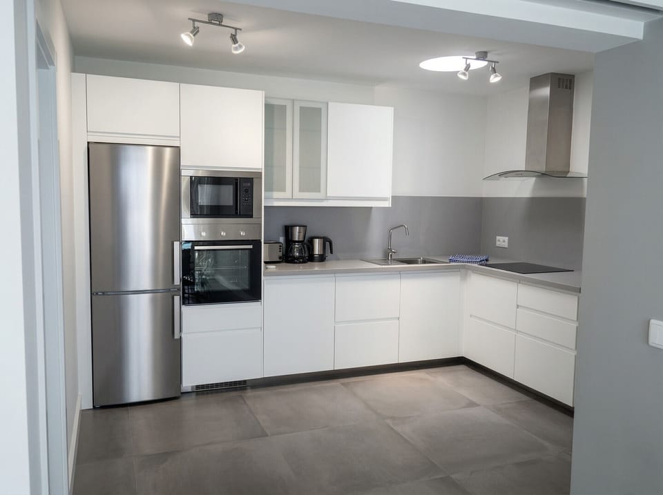 Everything you need: modern kitchen equipped with stainless steel appliances.