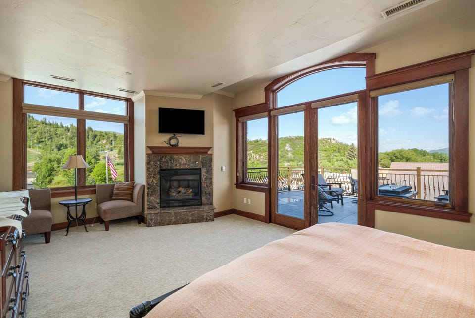 Very spacious primary bedroom with gas fireplace and TV