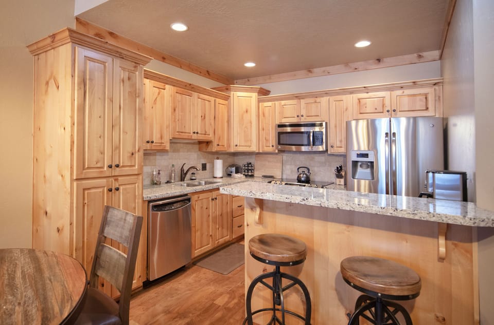Your chef's paradise awaits with warm wood cabinetry, granite countertops, and top-tier stainless steel appliances. Gather at the breakfast bar while you prepare memorable meals together.