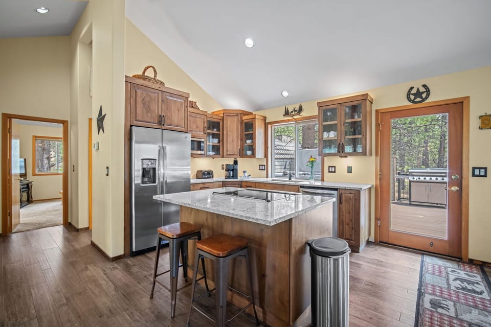 Alderwood custom cabinets w/ etched glass.  SS appliances & granite tops.