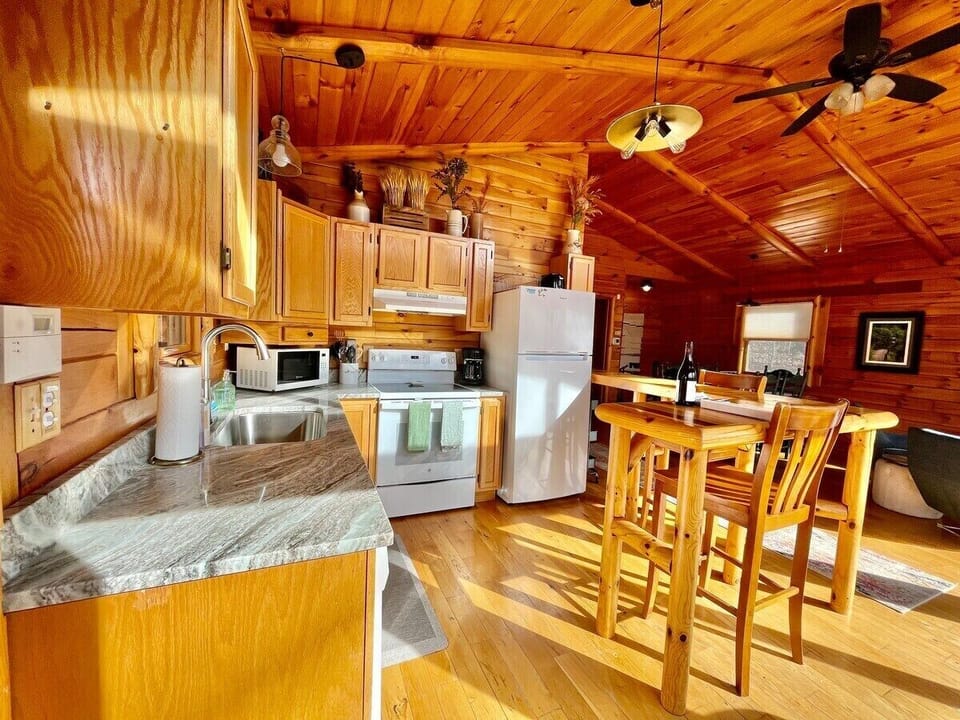 Kitchen with granite countertops and wood bartop area.