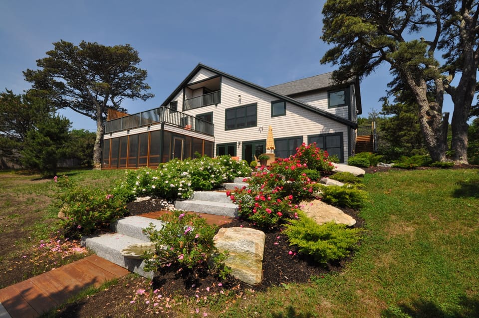Beach side view of the house with the roses blooming