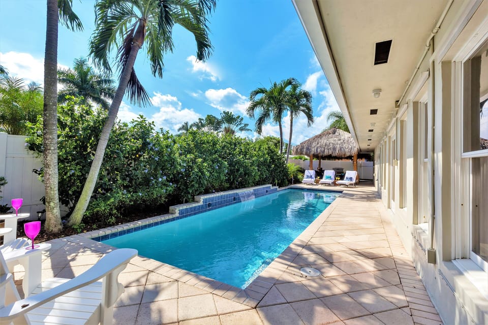 View of Pool from East Side of Property with Comfortable Adirondacks and Grill 