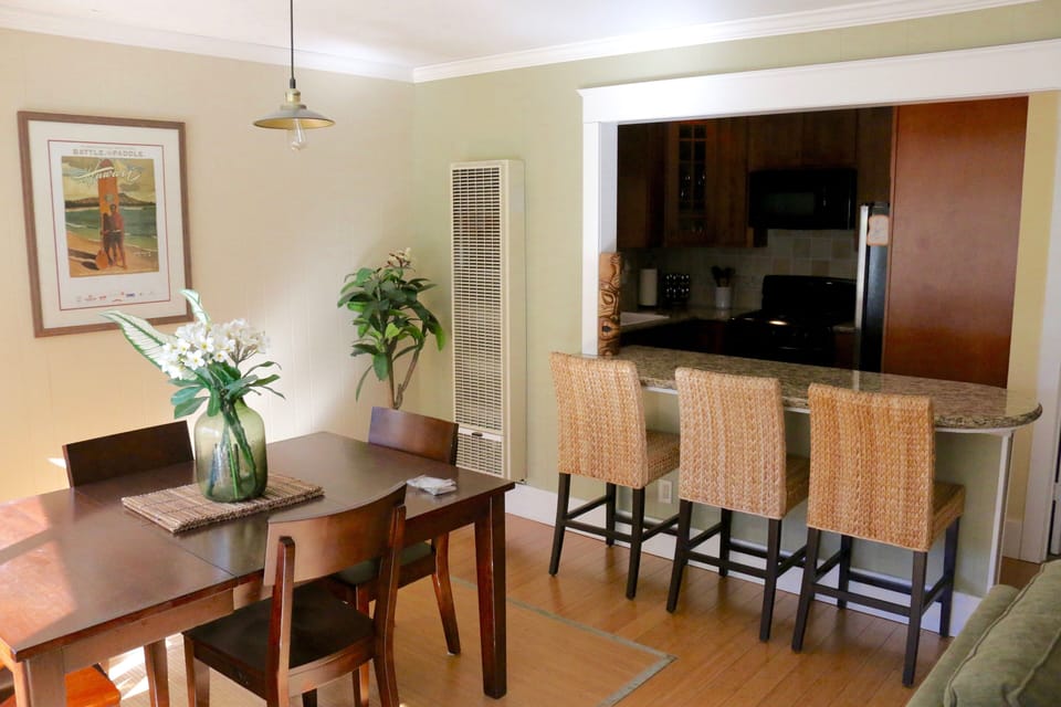 Dining table and kitchen peninsula which seats 3