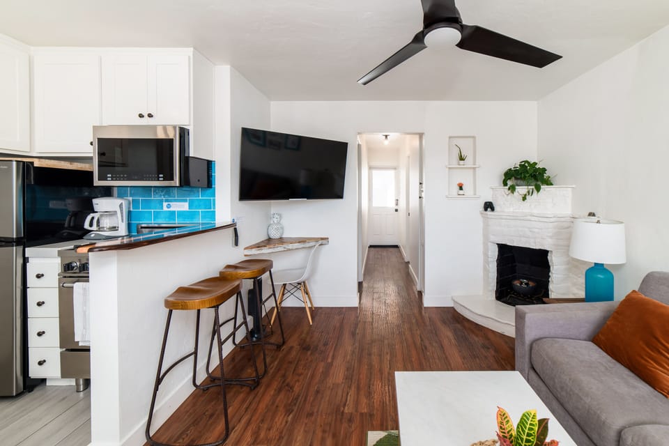 Partial ocean view living room with smart television. Netflix and HULU with Live TV accounts signed in for guest use.