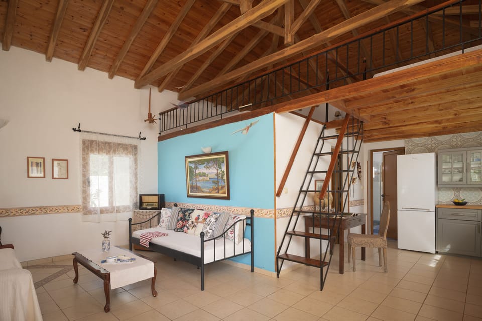 Panoramic view of the living room, kitchen, dinning area & attic bedroom.