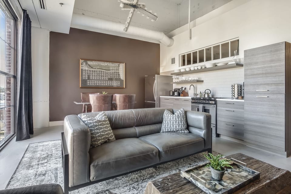 Living Area with Gray Leather Sofa at Ponce City Market Apartment