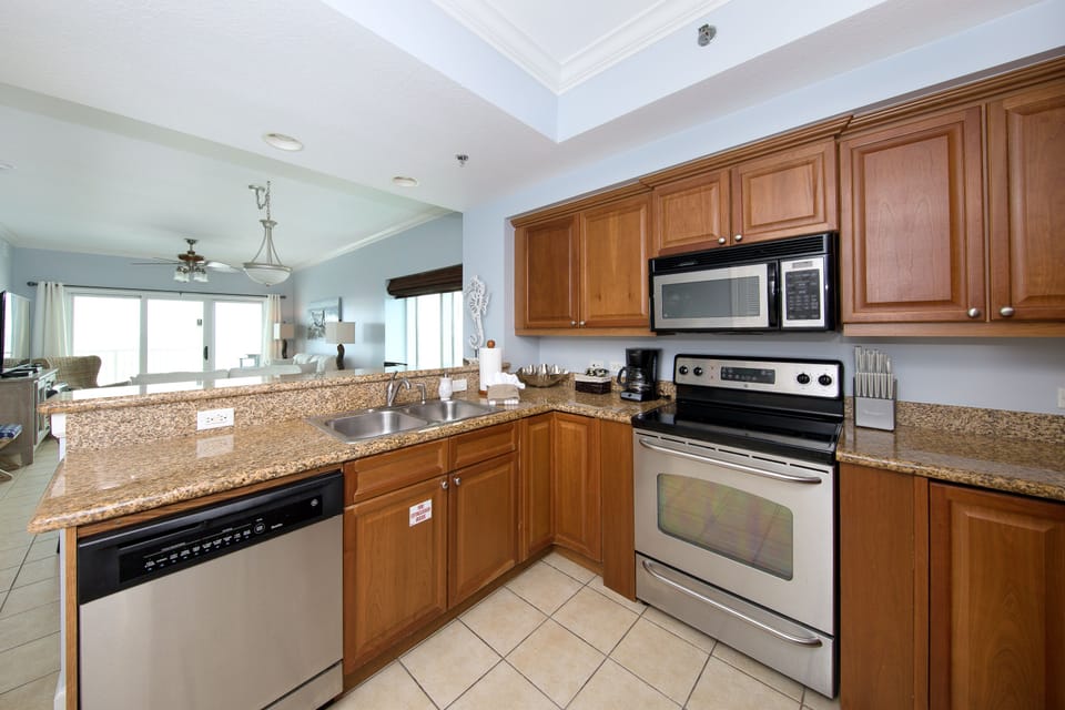 Spacious Kitchen with granite counter tops to prepare meals.