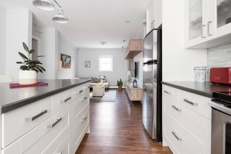 Bright kitchen and dining area featuring sleek appliances and a generous island—ideal for preparing meals, sharing conversations, and relaxing in style.