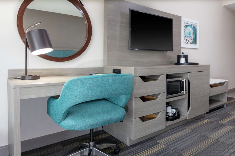 Premium bedding, desk, laptop workspace, iron/ironing board