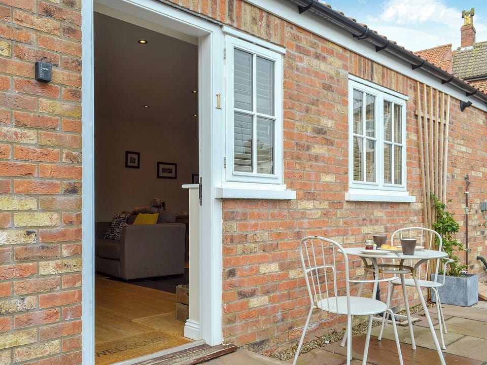 Sitting-out area with garden furniture | 1 Croft Cottage - Croft Cottage Holidays, Stillington, near Easingwold