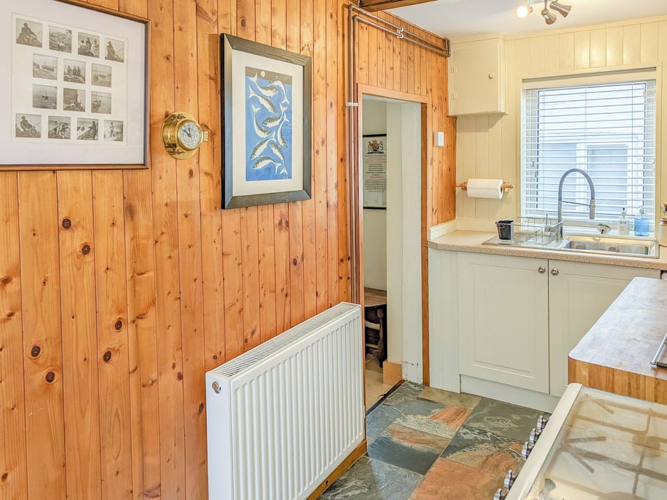 Kitchen with cosy ship&rsquo;s galley feel | Trinity Cottage, Wells-next-the-Sea