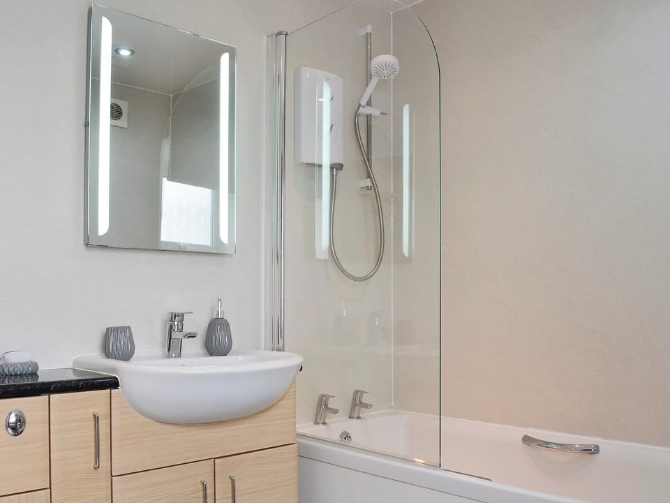 Bathroom with shower over the bath | Creel Cottage, Auchmithie, near Arbroath