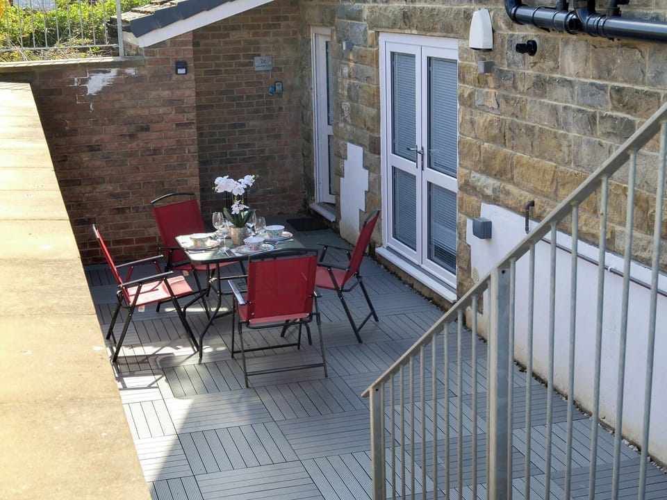 Enclosed sitting-out area with garden furniture | The Hideaway, Sleights, near Whitby