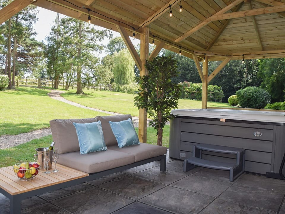 Covered setaing area by the hot tub | Twisly North Lodge, Catsfield, near Battle