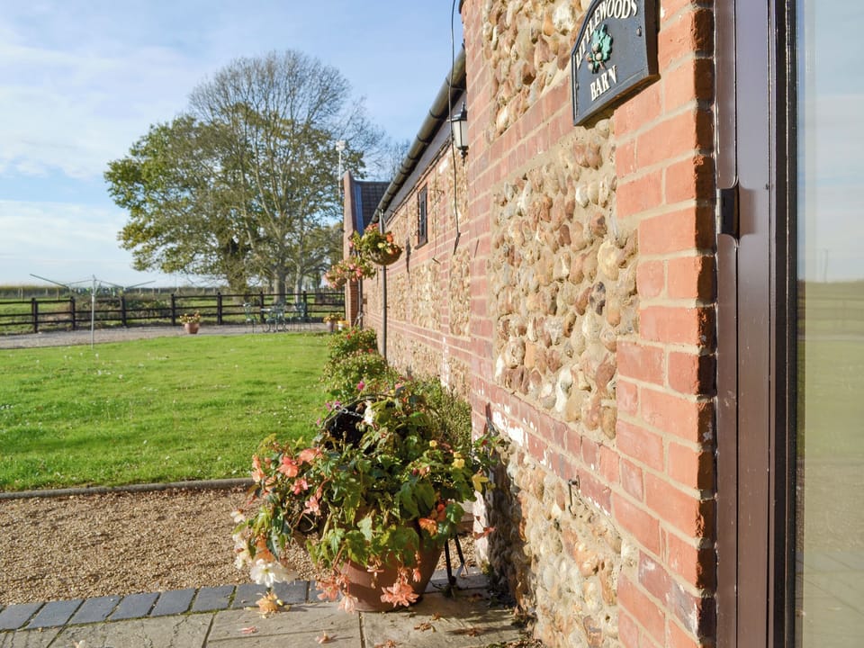 Lawned garden area at front of property | Littlewoods Barn - Moor Farm Stable Cottages, Foxley, near Fakenham