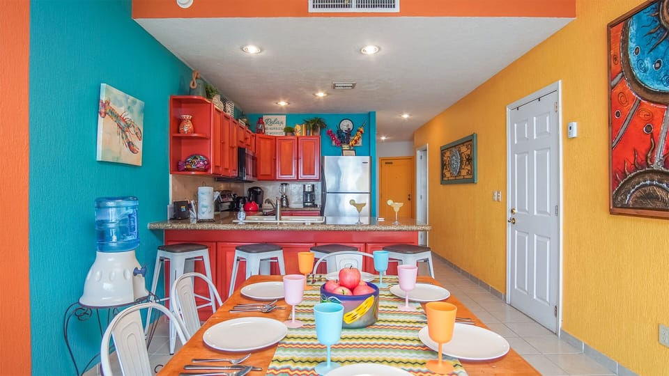 The dining table and kitchen.
