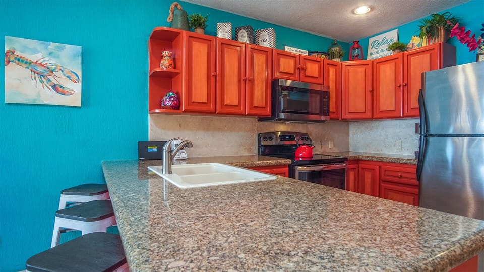 The kitchen features all appliances and lots of counters and cabinets.