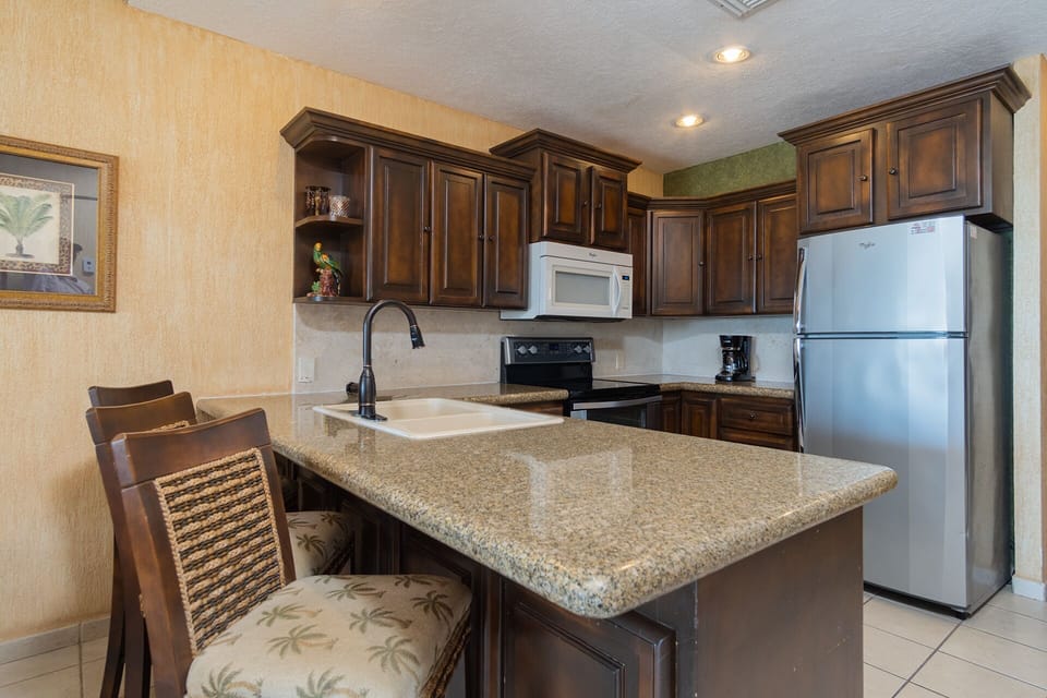 The kitchen, complete with bar stools.