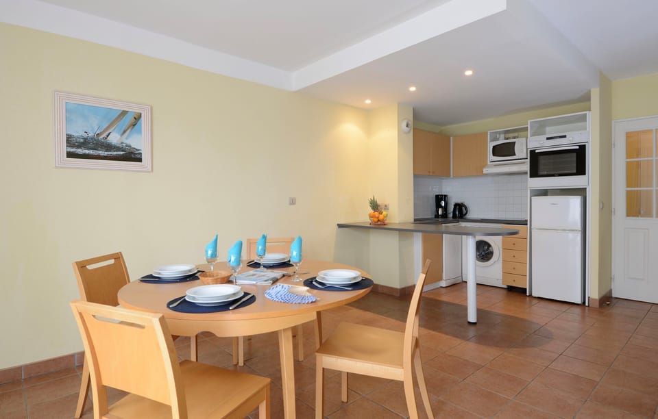 Prepare meals in the kitchenette and enjoy them at the dining table.