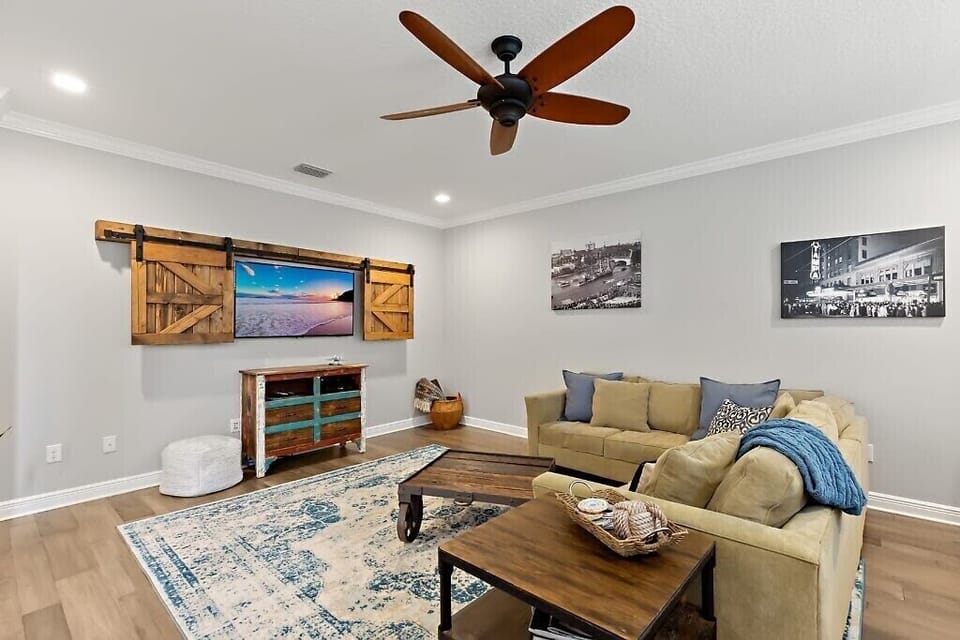 Steps from the kitchen, enjoy our 55” TV w/rustic decor, including games for all
