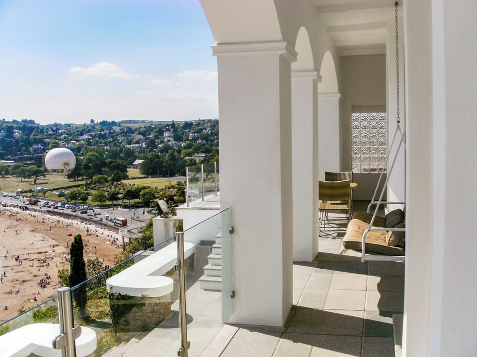 Balcony show the swing seat and view | Riviera Apartment, Torquay