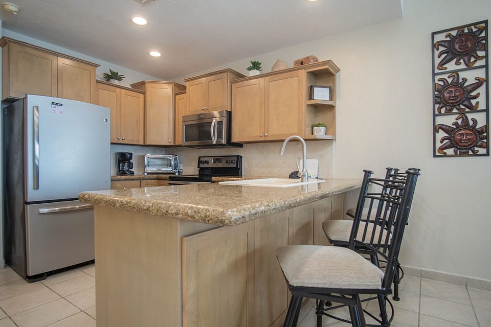 kitchen counter with bar stools