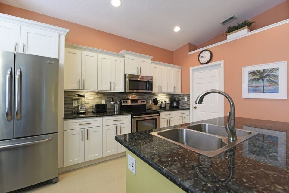 Sleek kitchen design with granite countertops and stainless-steel appliances.