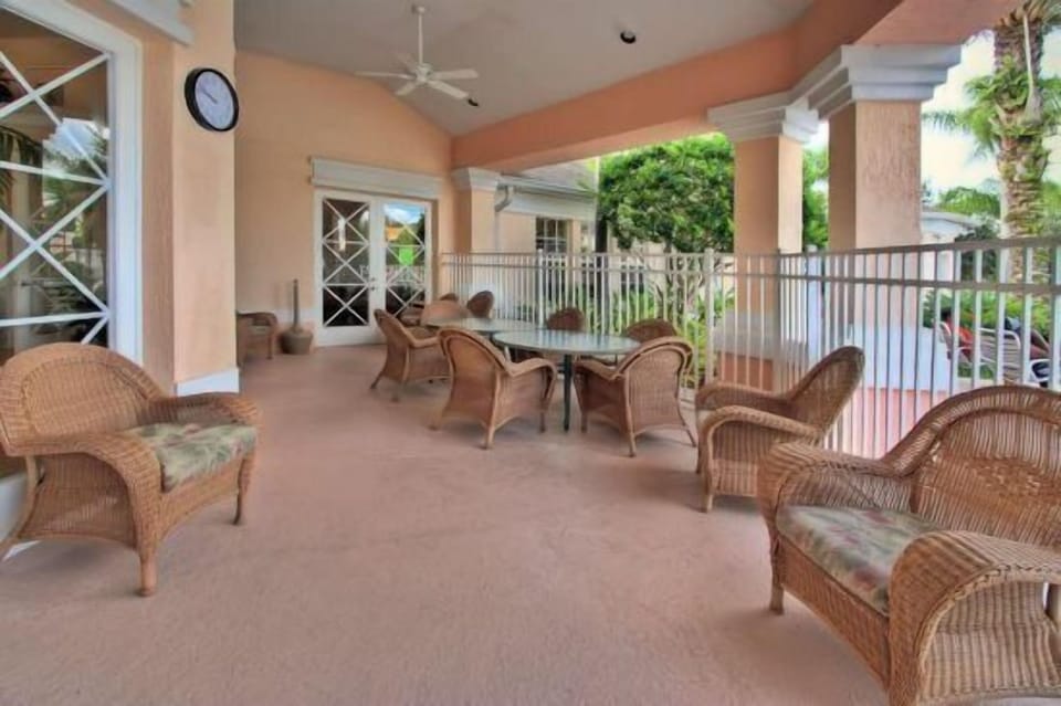 Relax in the breezy clubhouse patio with comfortable seating and scenic views.