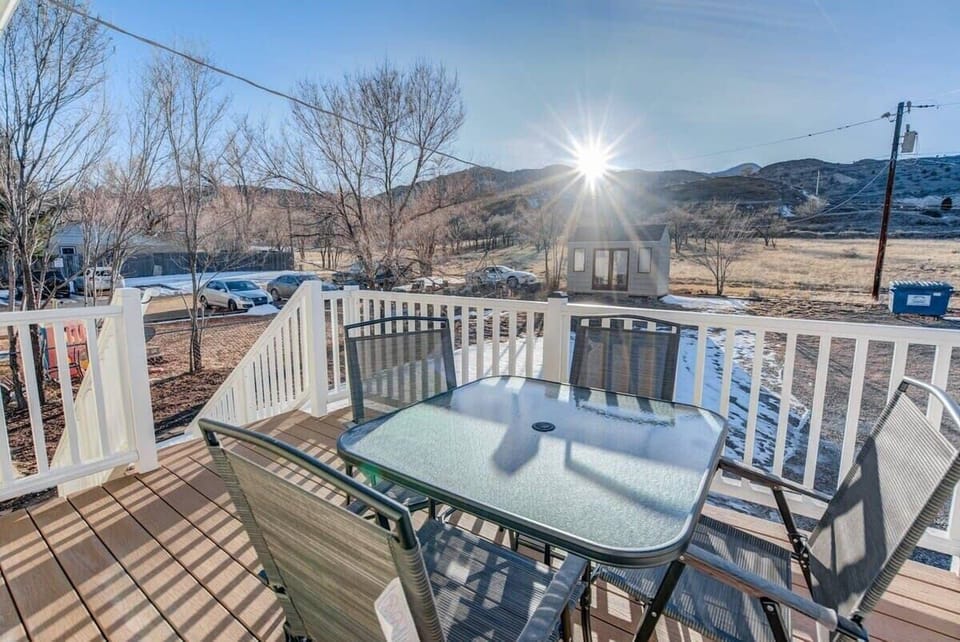 Soak up sunshine on the deck, gathered around the glass-top table with wide-open views beyond the railing.