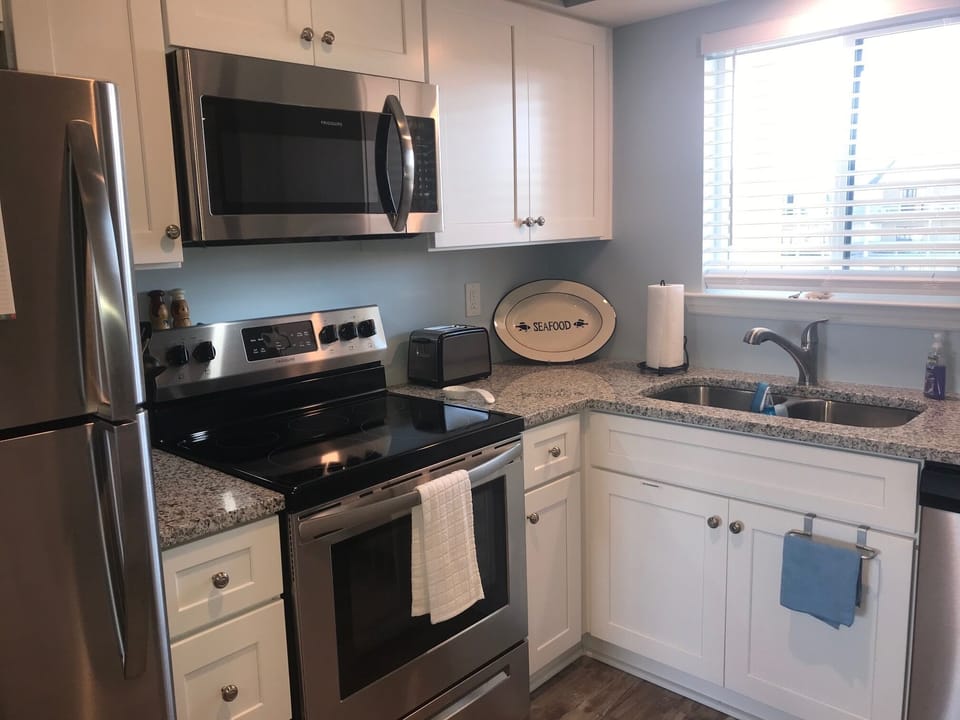 New appliances - Fully Stocked kitchen -  View of pool area from kitchen window.
