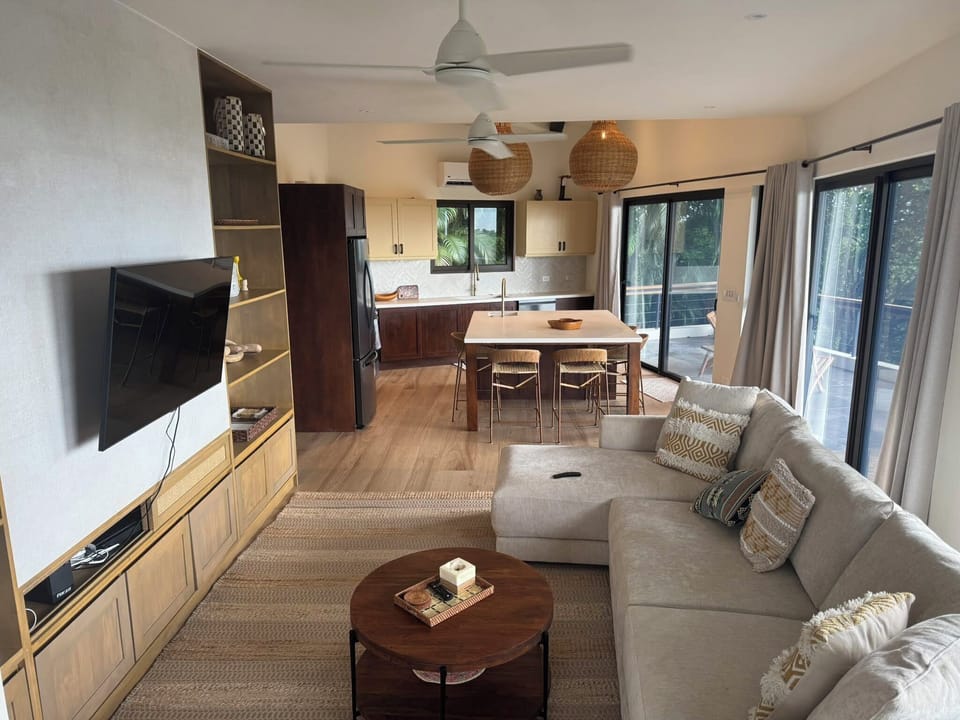 The kitchen faces a spacious, cozy living space