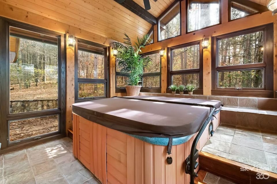 Hot tub cover easily folds over the metal frame, lifting it out of the way when in use.