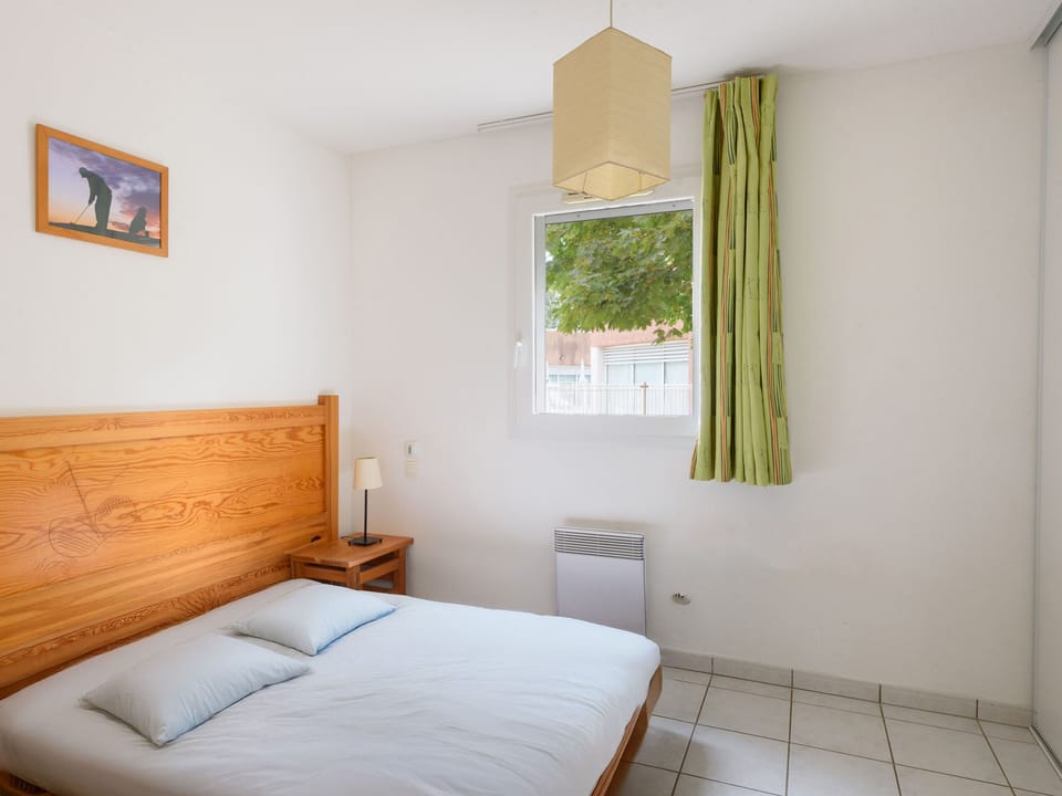 Bright and airy, the second view of the bedroom highlights its tranquil ambiance with ample natural light.