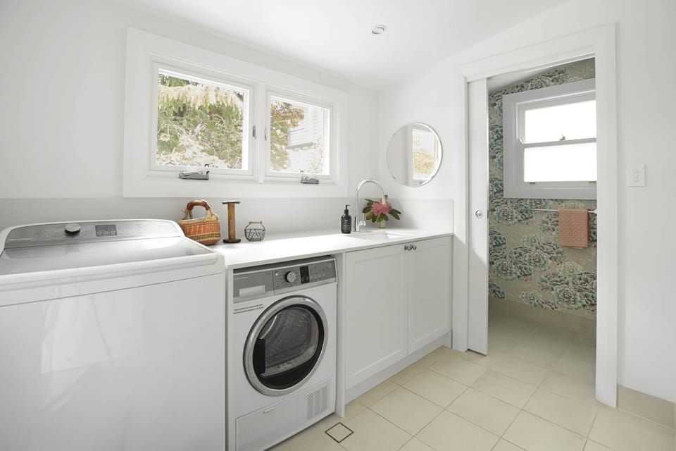 Laundry connecting to rear bathroom with shower and toilet. 