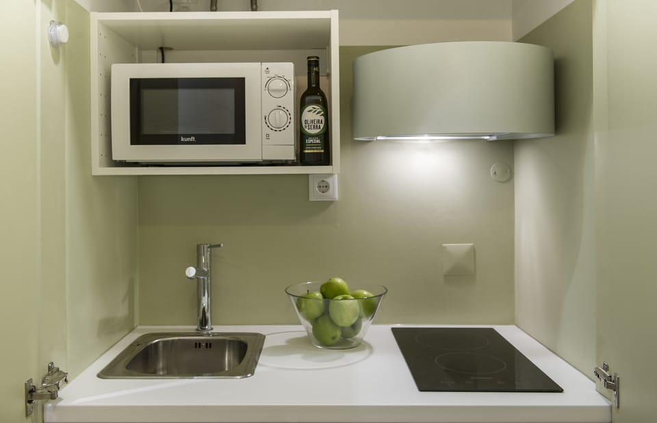 The kitchenette is small, but equipped with stove, microwave, coffee machine