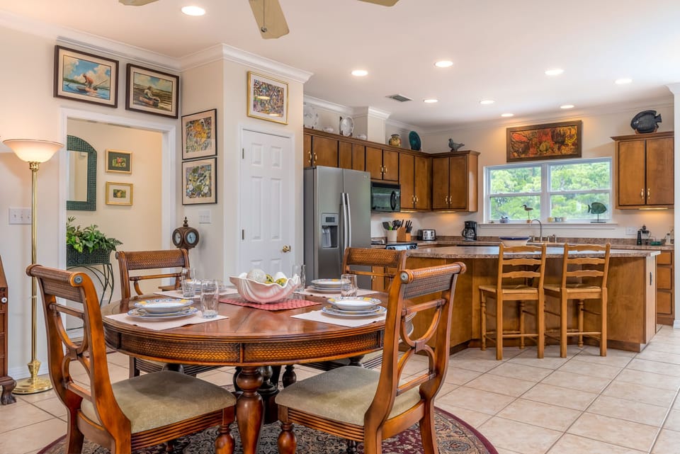Your elegant dining space flows into a fully-equipped kitchen where morning coffee and home-cooked meals become vacation memories.