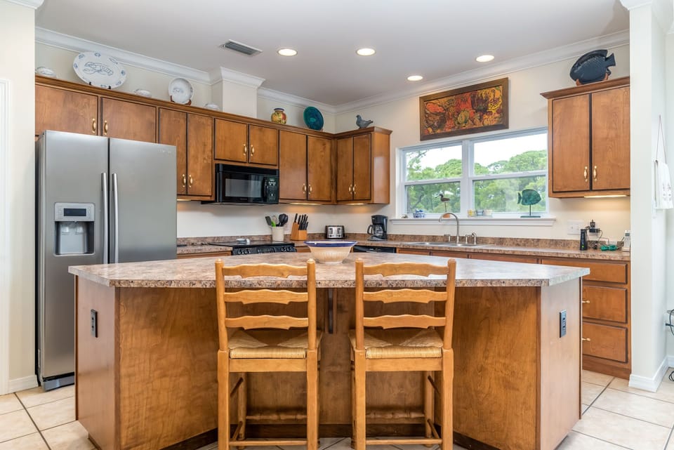 Your fully equipped kitchen features stainless appliances, and a breakfast island where you'll love starting each morning.