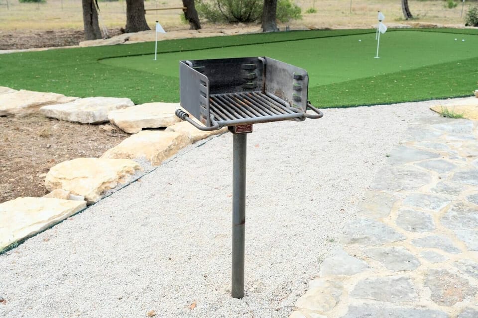 The grille is located next to the firepit and putting green.  Bring charcoal and have a cookout!
